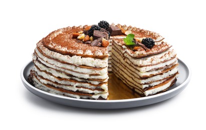 Photo of Tasty crepe cake with cocoa powder, chocolate, nuts, blackberries and mint isolated on white