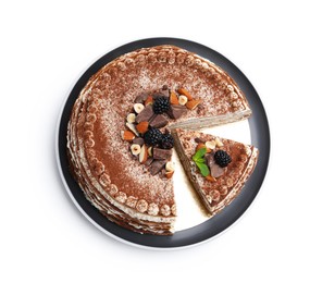 Photo of Tasty crepe cake with cocoa powder, chocolate and nuts isolated on white, top view