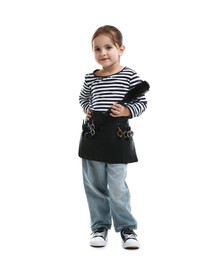 Photo of Choice of profession. Cute little girl with tools pretending to be hairdresser on white background