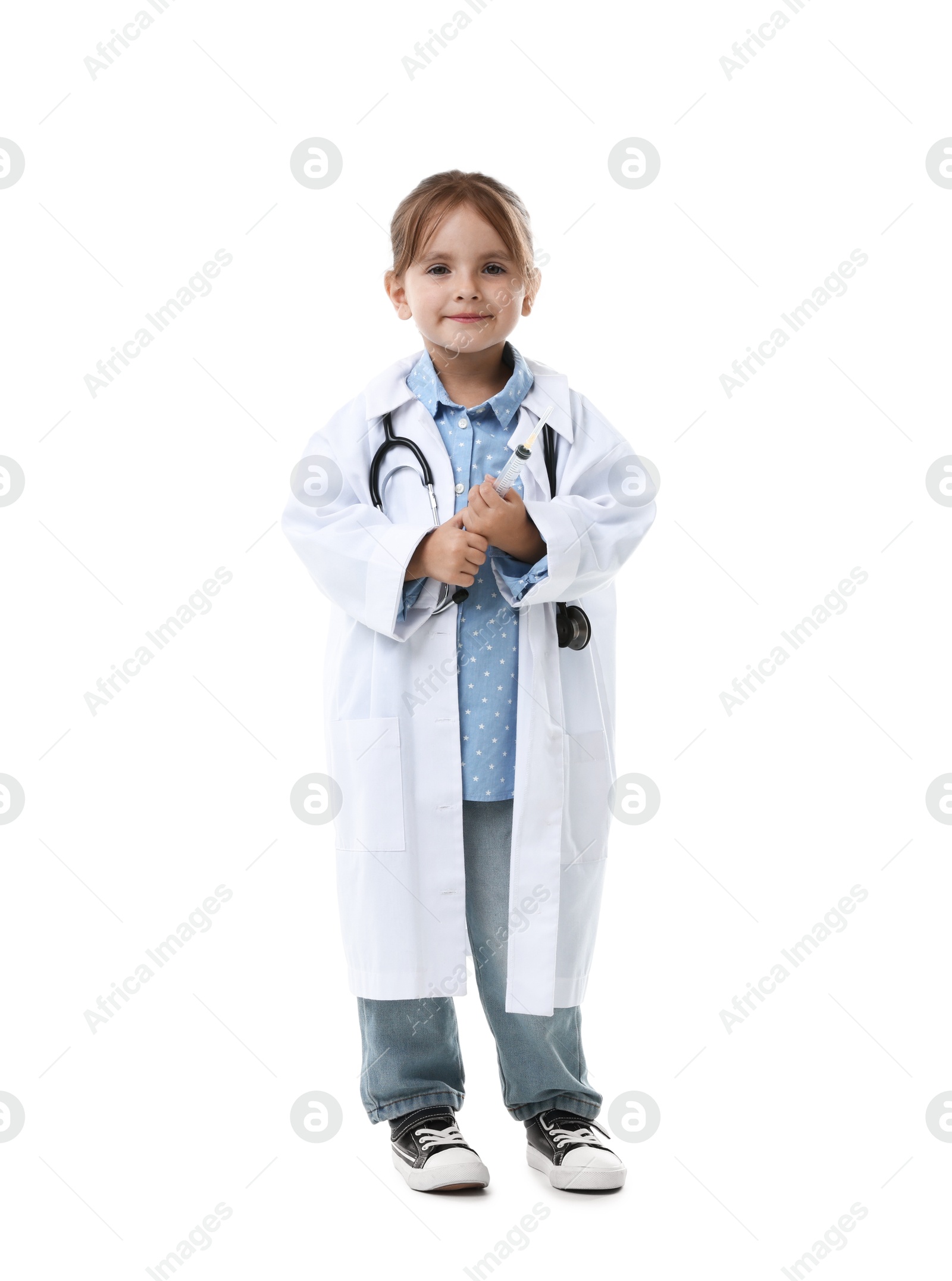 Photo of Choice of profession. Little girl in uniform with stethoscope and syringe pretending to be doctor on white background