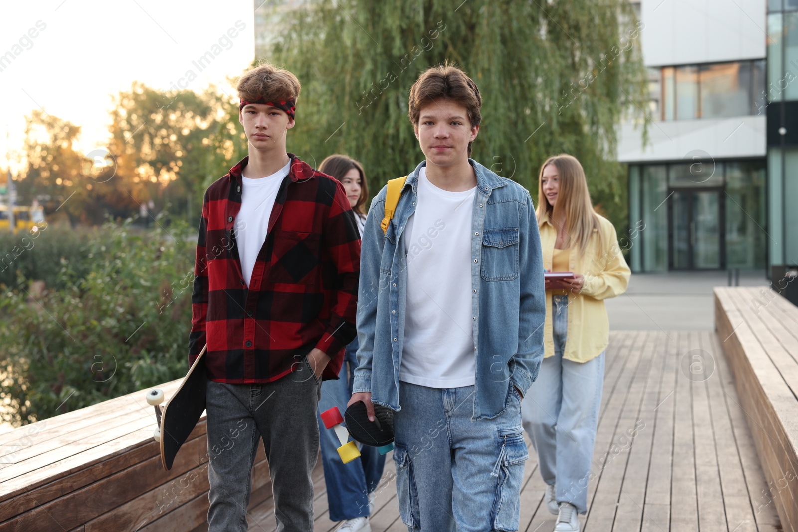 Photo of Group of teenagers walking on city street