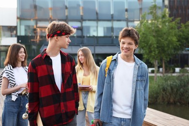 Photo of Group of teenagers walking on city street