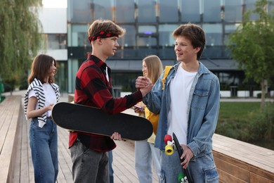Photo of Group of teenagers walking on city street
