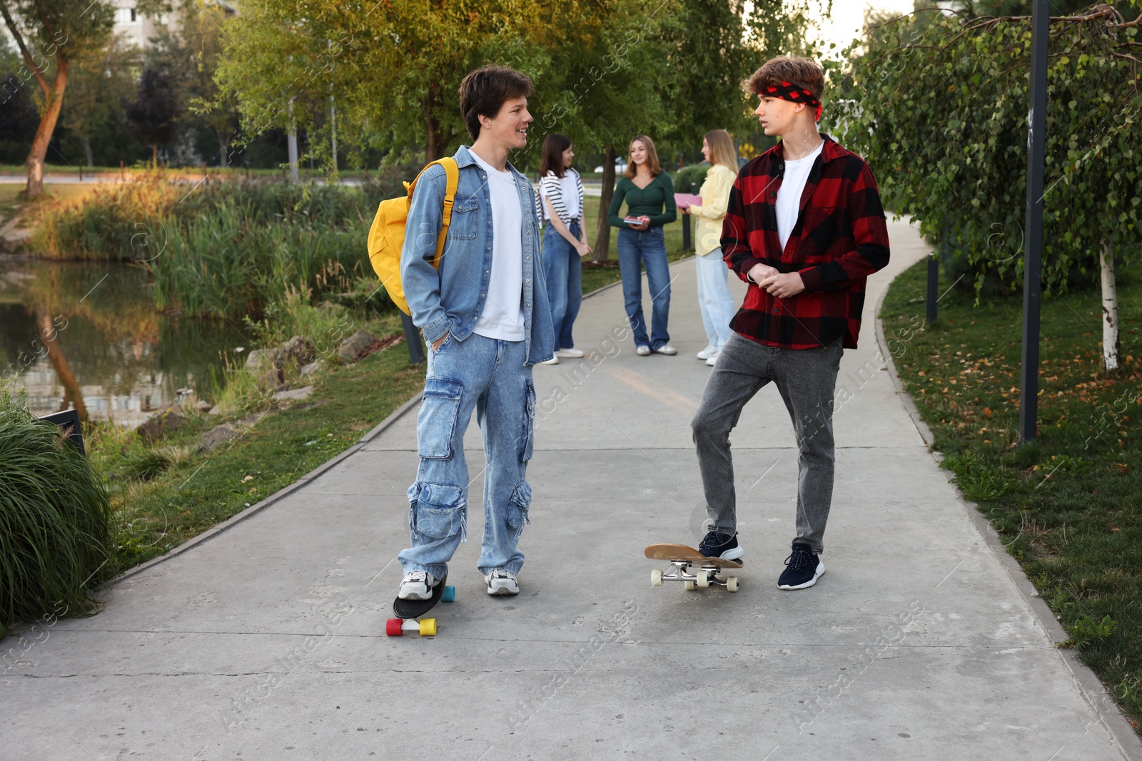 Photo of Group of teenagers walking on city street, selective focus