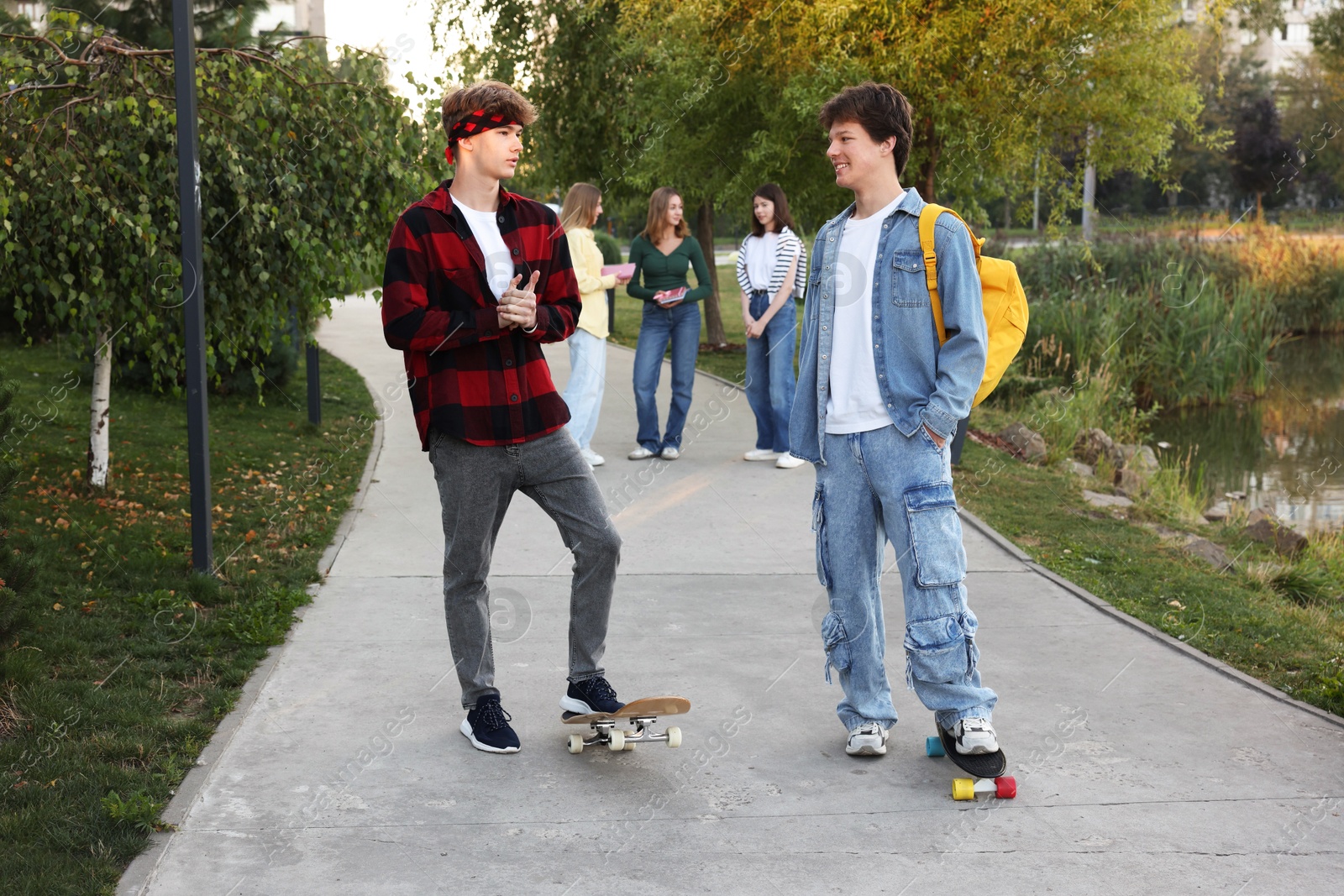 Photo of Group of teenagers walking on city street, selective focus