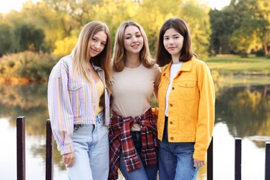 Photo of Portrait of teenage girls near lake outdoors