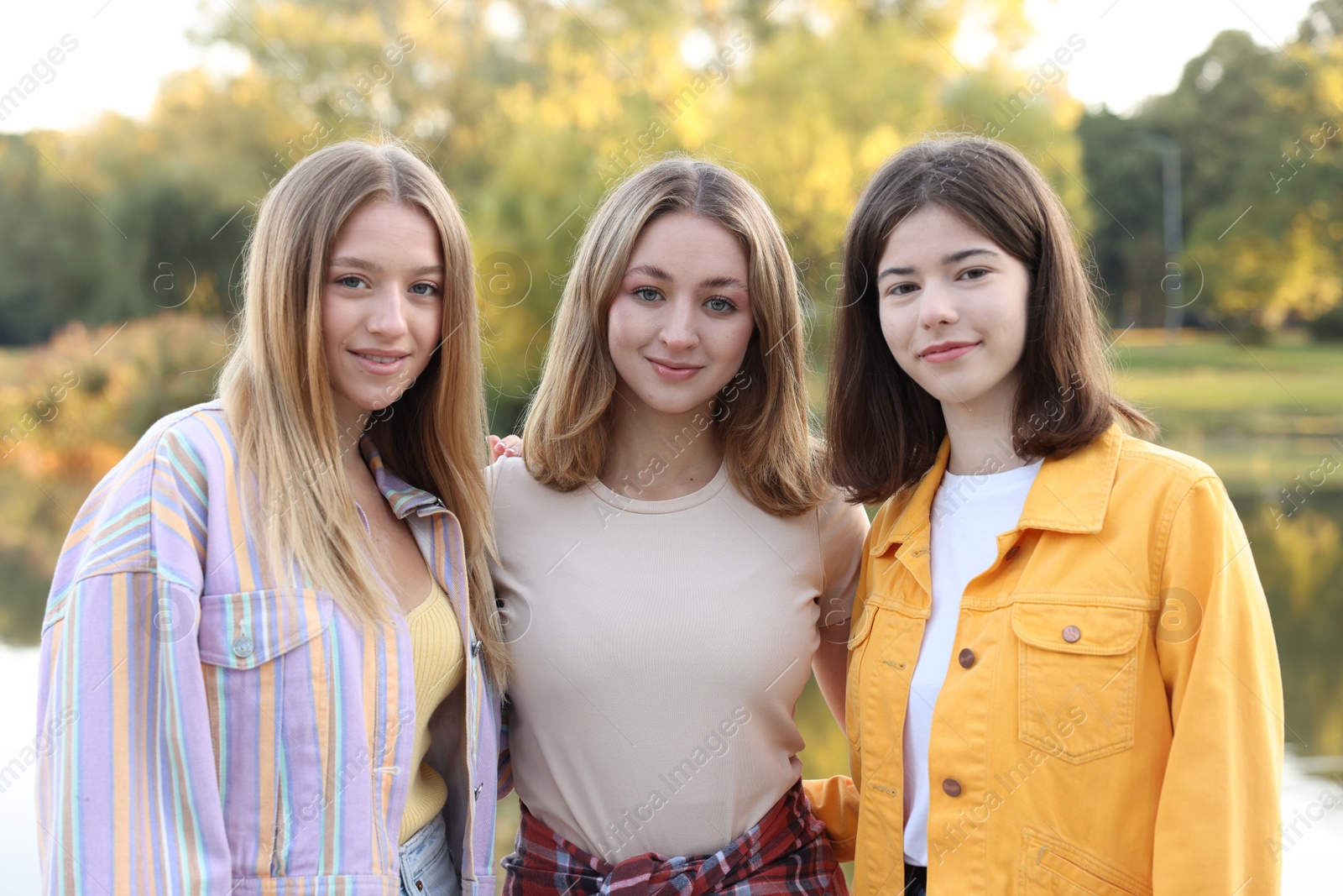 Photo of Portrait of teenage girls near lake outdoors