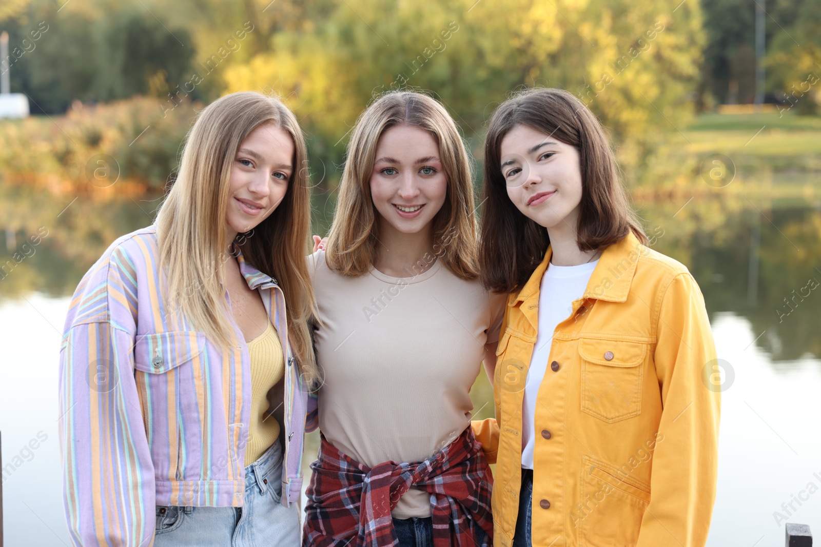 Photo of Portrait of teenage girls near lake outdoors