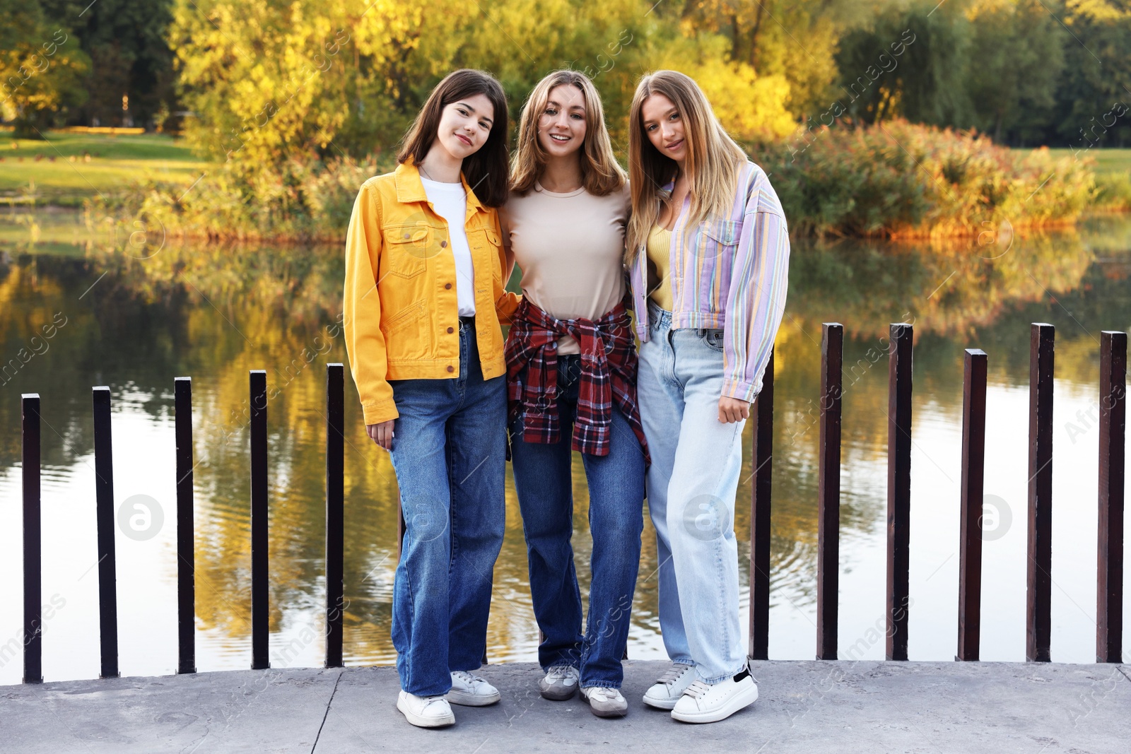 Photo of Portrait of teenage girls near lake outdoors