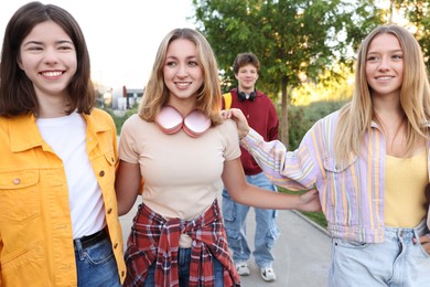 Photo of Group of teenagers walking on city street