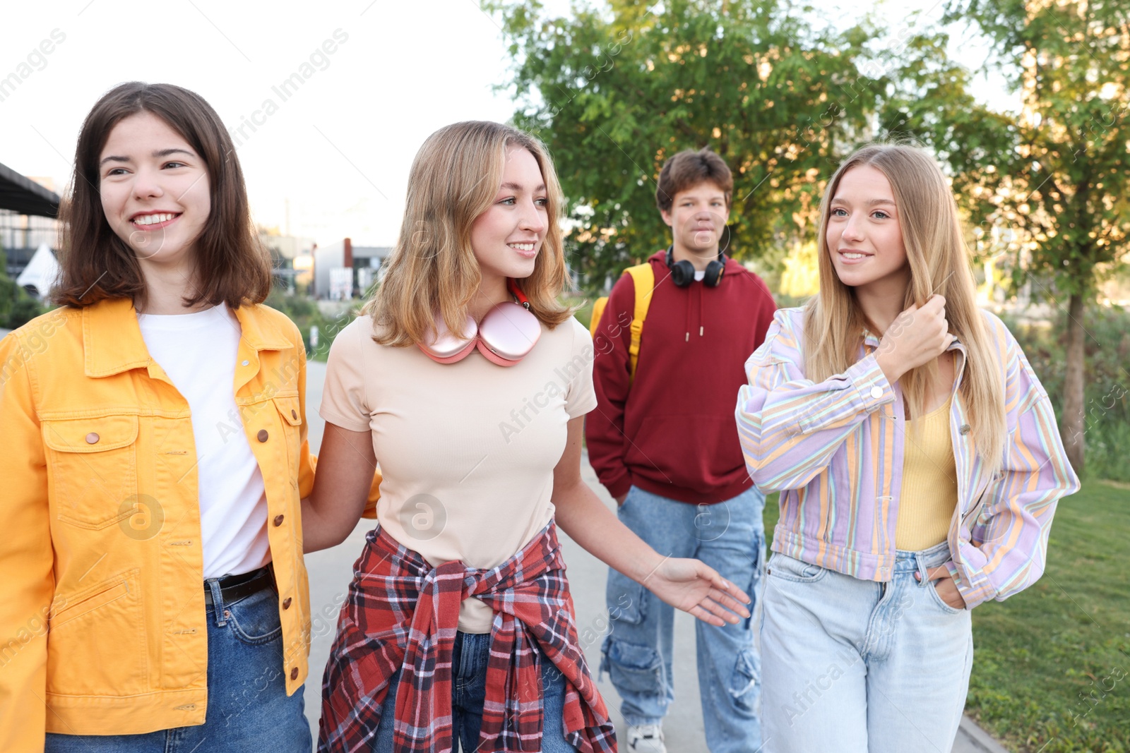 Photo of Group of teenagers walking on city street