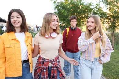 Photo of Group of teenagers walking on city street