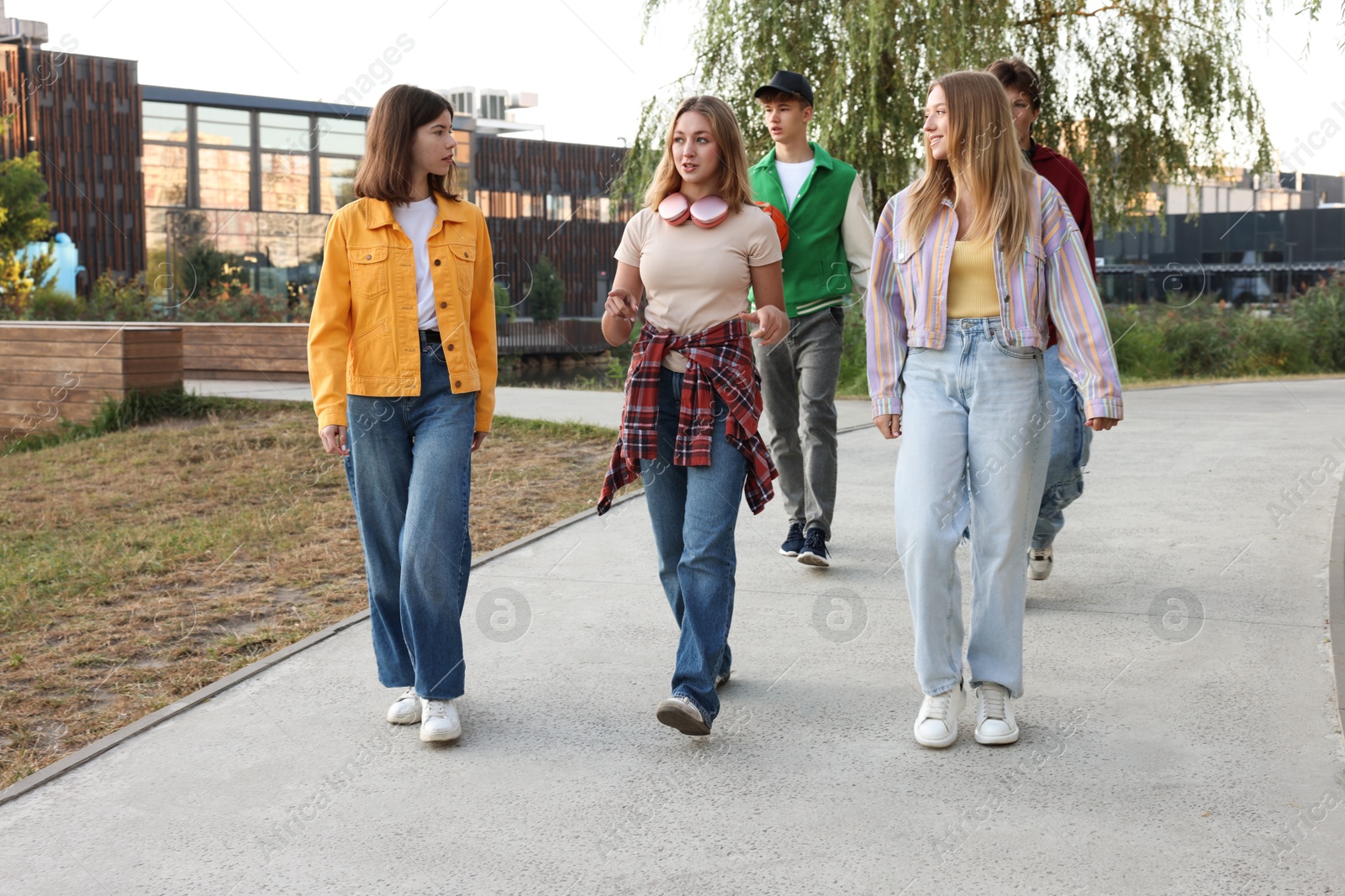 Photo of Group of teenagers walking on city street