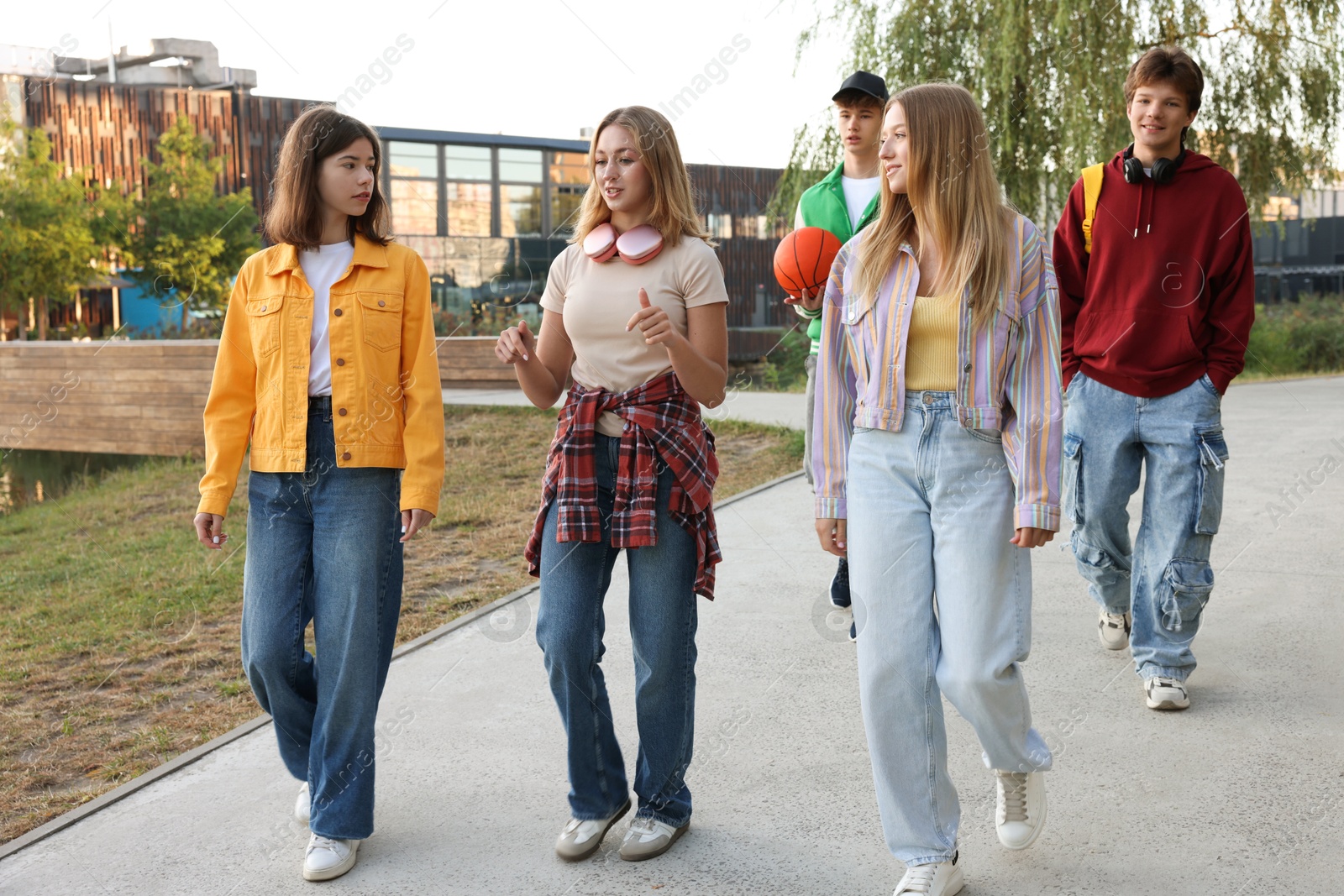 Photo of Group of teenagers walking on city street