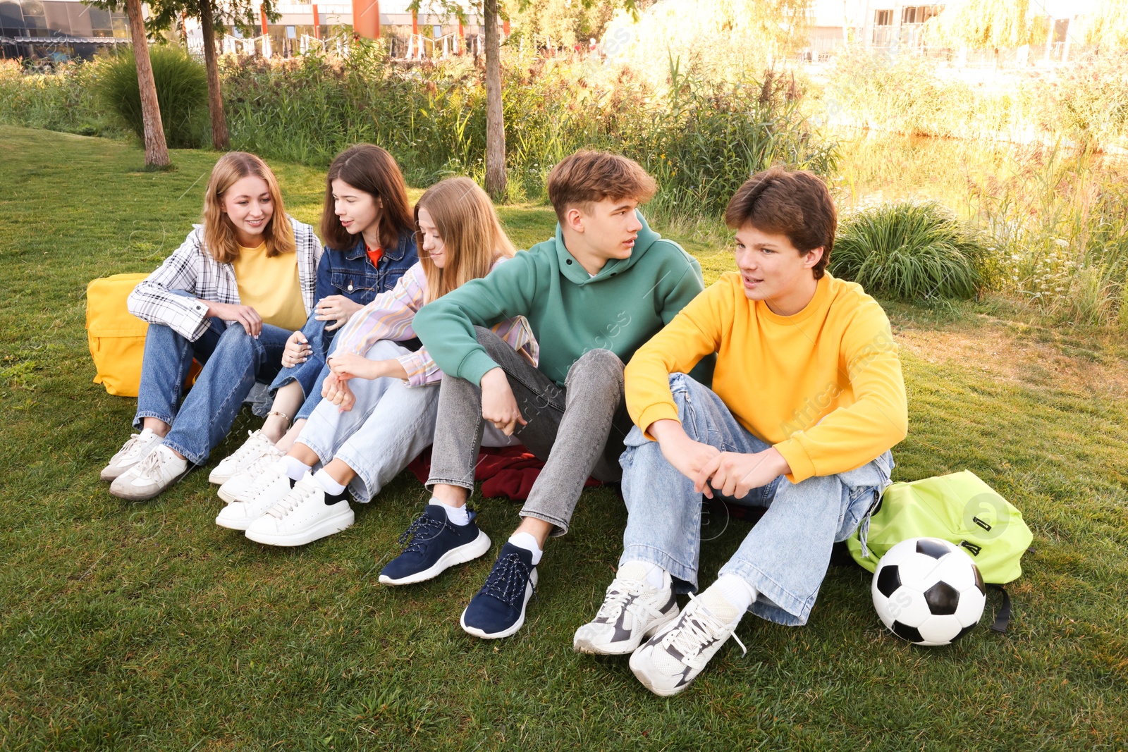 Photo of Group of teenagers spending time together in park