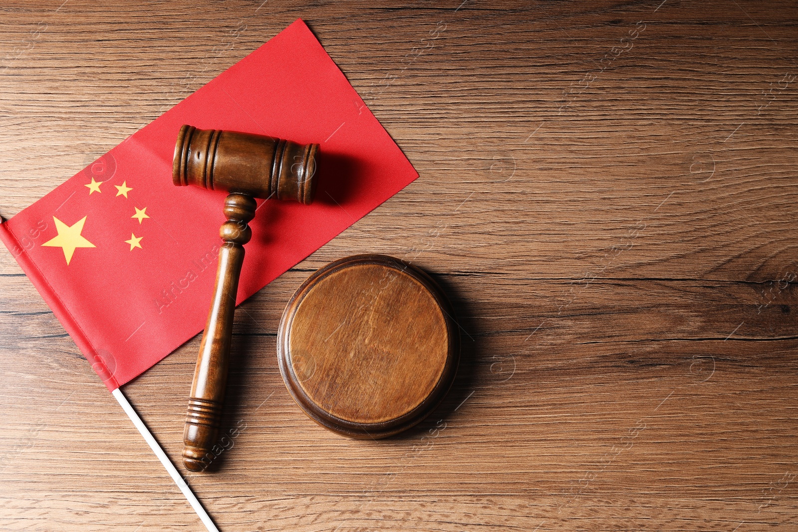 Photo of Judge's gavel and flag of China on wooden table, top view. Space for text