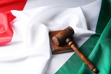 Photo of Wooden judge's gavel on flag of Italy