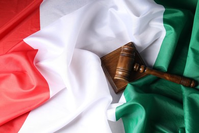 Photo of Judge's gavel on flag of Italy, top view