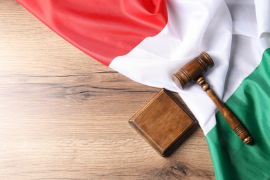 Photo of Judge's gavel and flag of Italy on wooden table, top view. Space for text
