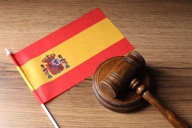 Photo of Judge's gavel and flag of Spain on wooden table