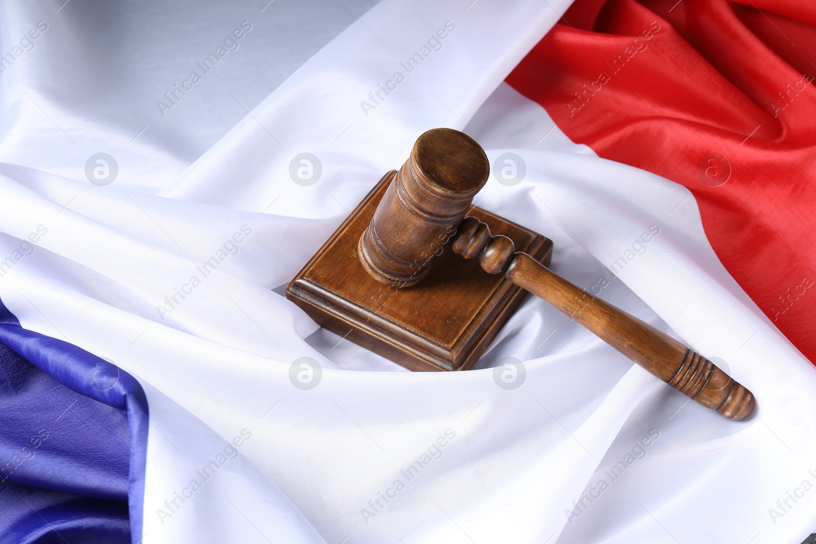 Photo of Wooden judge's gavel on flag of France