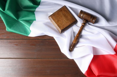 Photo of Judge's gavel and flag of Italy on wooden table, top view. Space for text