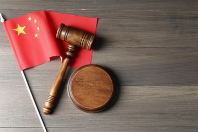 Photo of Judge's gavel and flag of China on wooden table, top view. Space for text