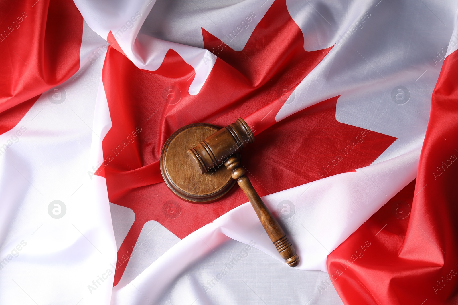 Photo of Judge's gavel on flag of Canada, top view