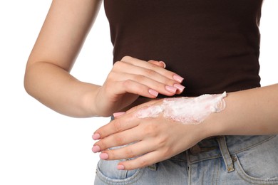 Photo of Woman applying healing cream onto burned hand on white background, closeup