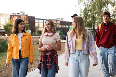 Photo of Group of teenagers walking on city street