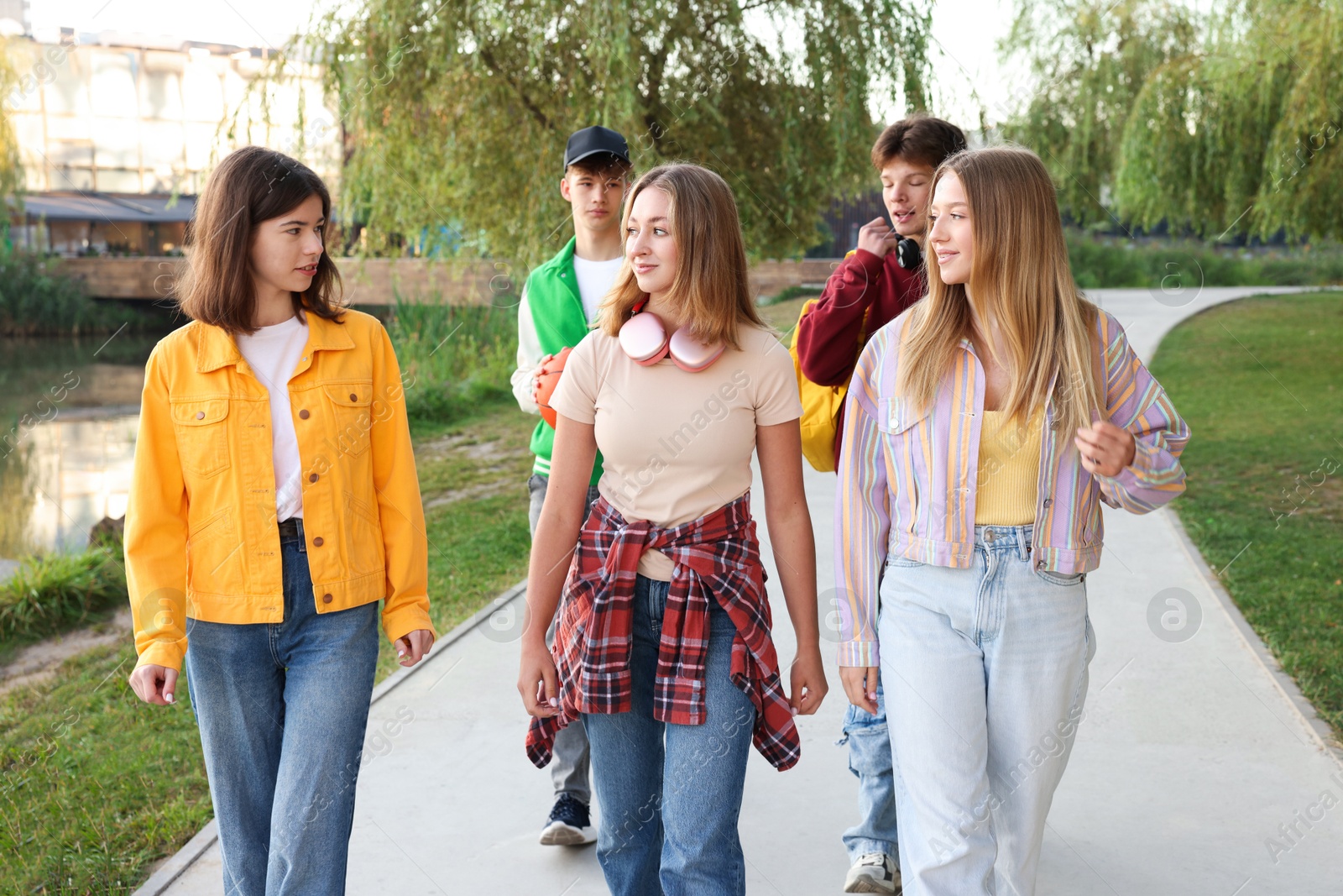 Photo of Group of teenagers walking on city street