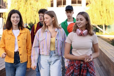 Photo of Group of teenagers walking on city street