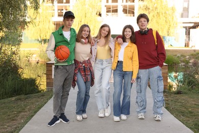 Photo of Group of teenagers walking on city street