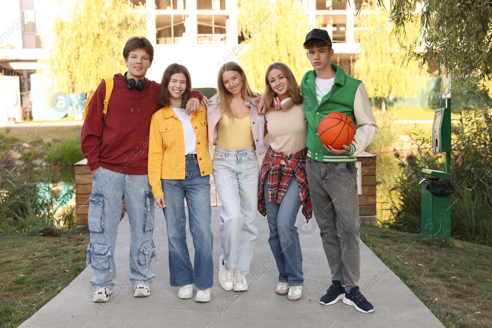 Photo of Group of teenagers walking on city street