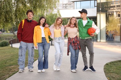 Photo of Group of teenagers walking on city street