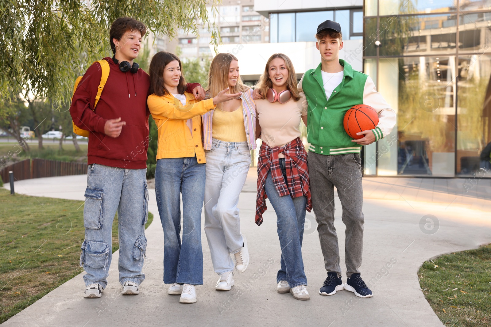 Photo of Group of teenagers walking on city street