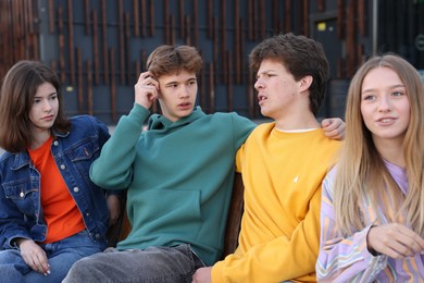 Photo of Group of teenagers spending time together outdoors