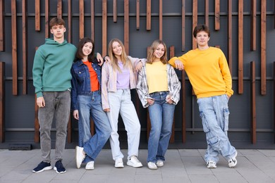 Photo of Group of teenagers near building on city street