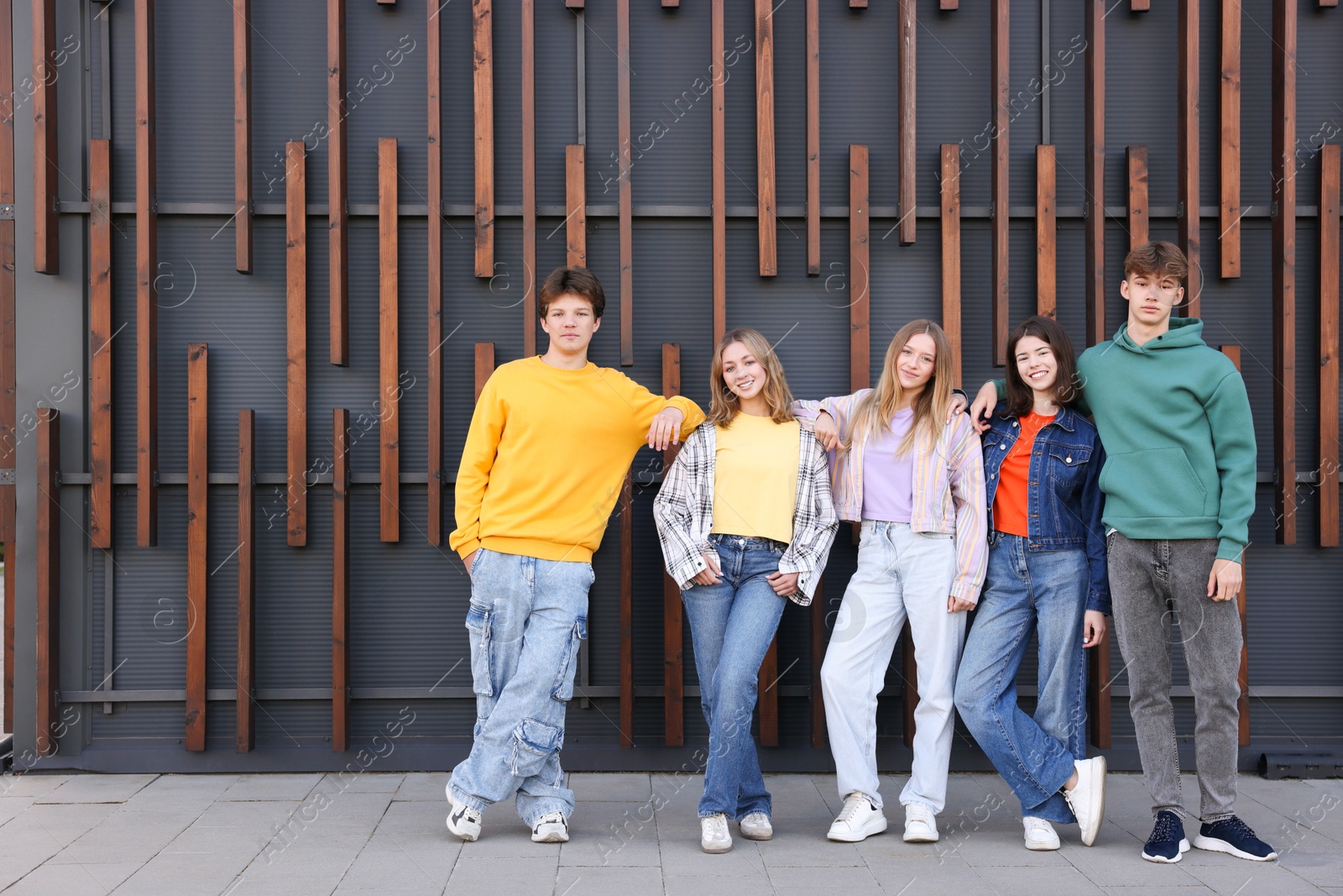 Photo of Group of teenagers near building on city street
