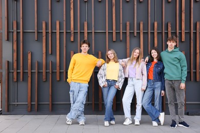 Photo of Group of teenagers near building on city street