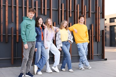 Photo of Group of teenagers near building on city street