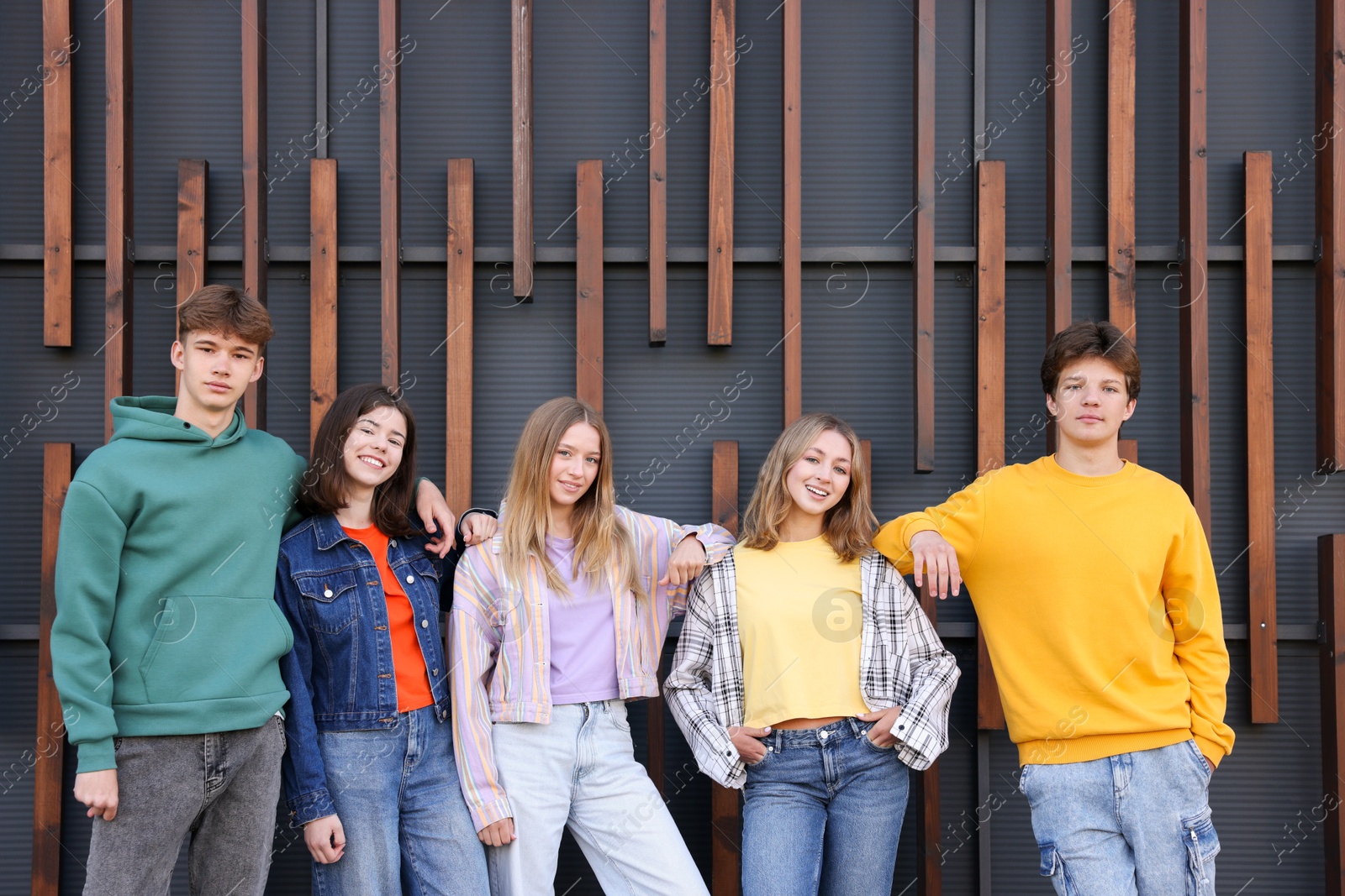 Photo of Group of teenagers near building on city street