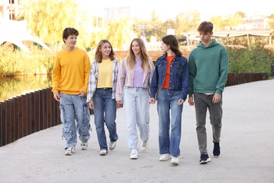 Photo of Group of teenagers walking on city street
