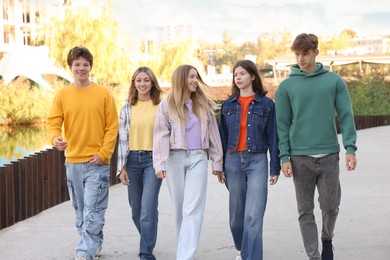 Photo of Group of teenagers walking on city street