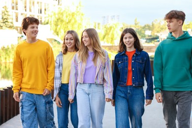 Photo of Group of teenagers walking on city street