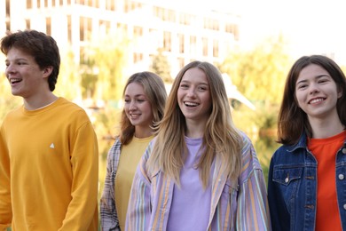 Photo of Group of teenagers walking on city street
