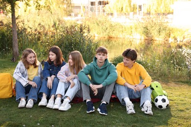 Photo of Group of teenagers spending time together in park