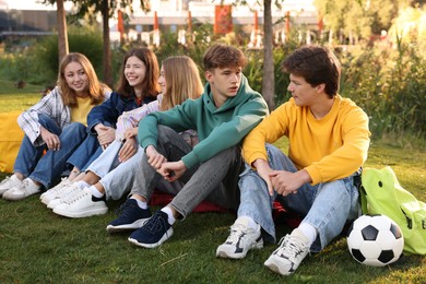 Photo of Group of teenagers spending time together in park