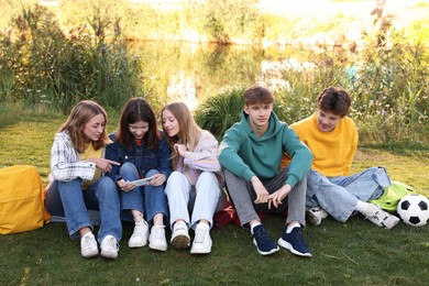 Photo of Group of teenagers spending time together in park