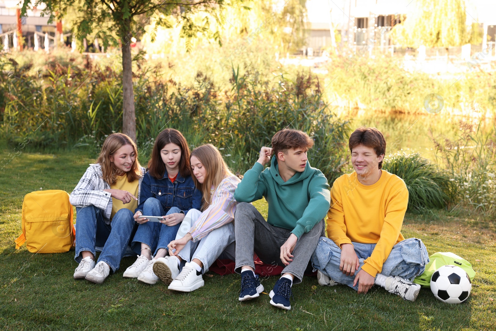Photo of Group of teenagers spending time together in park